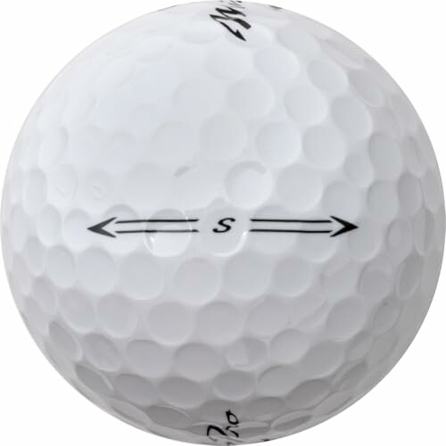 Close-up of a white golf ball with directional markings.
