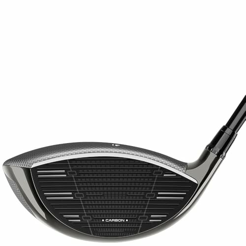 Close-up of a golf club driver head with carbon detailing.