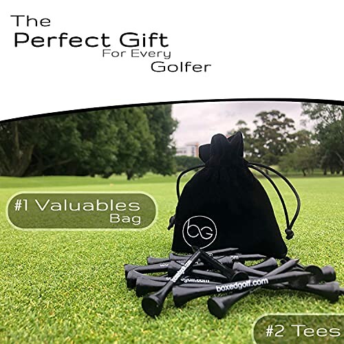 Golf gift set with black valuables bag and tees on grass