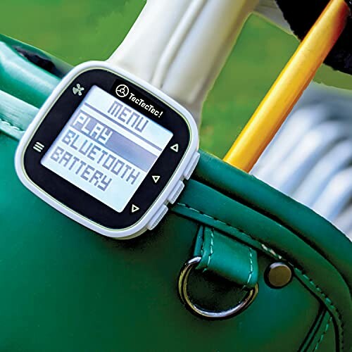 Golf GPS device displaying menu options on a golf bag.