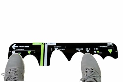 Golf training aid with foot placement guide for swing practice.