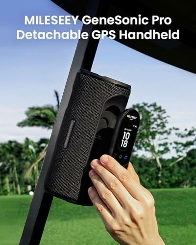 Hand holding MILESEEY GeneSonic Pro GPS device outdoors