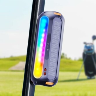 Portable Bluetooth speaker with LED lights attached to a pole outdoors.